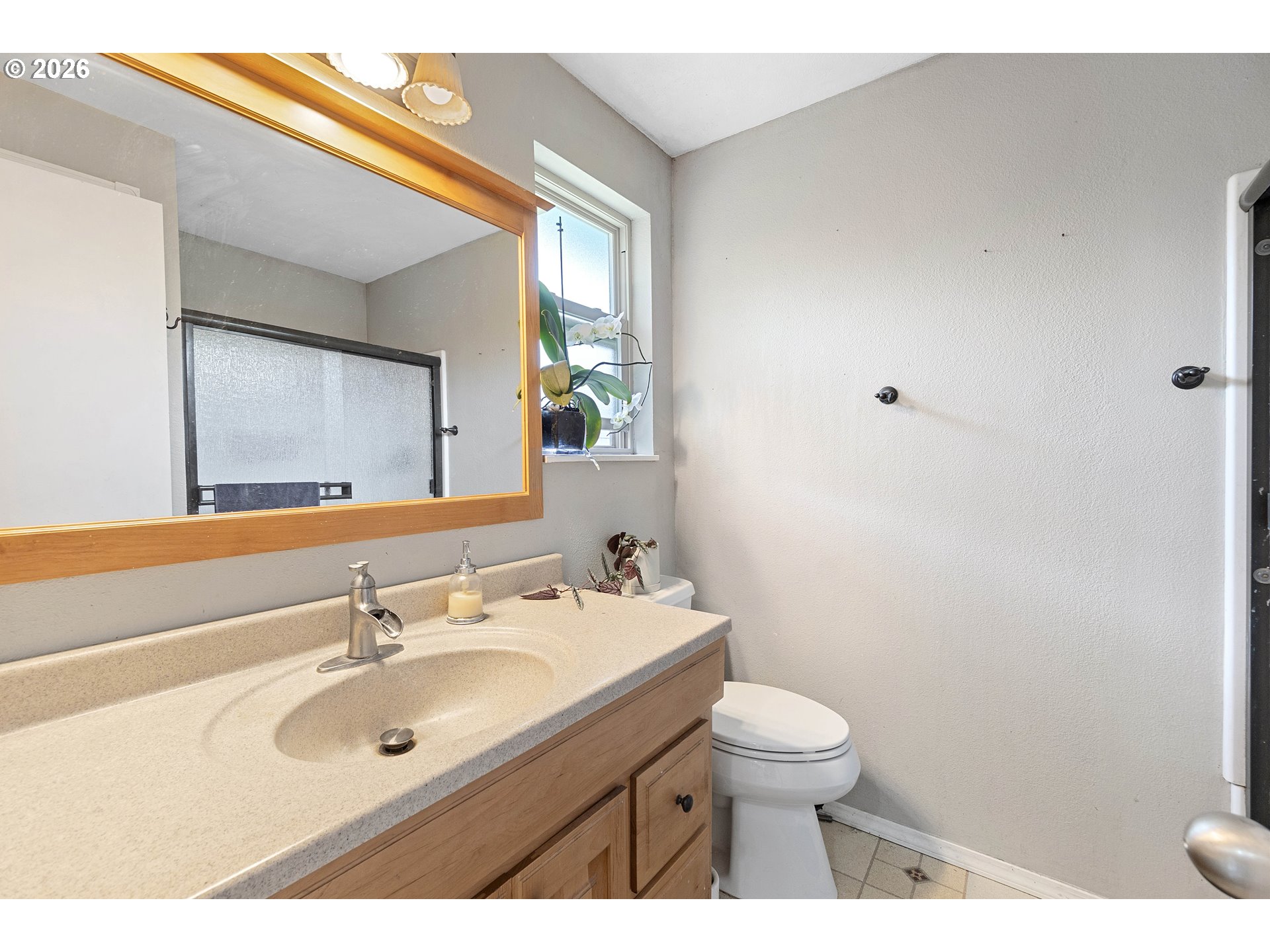 6749 Southwest 174th Place Beaverton, OR 97007 - Photo 32 of 39 a bathroom with a sink toilet a mirror and shower