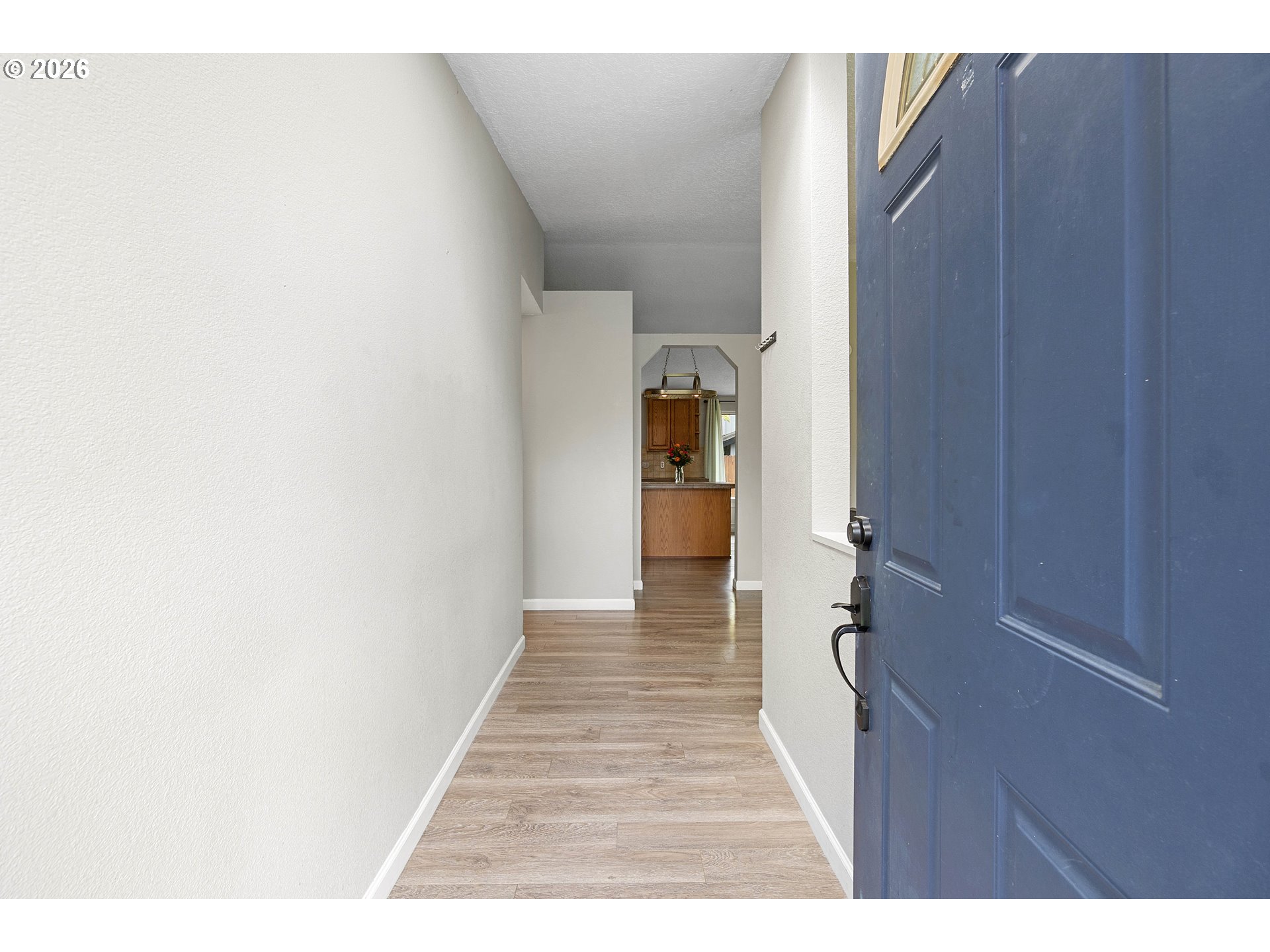 6749 Southwest 174th Place Beaverton, OR 97007 - Photo 4 of 39 a hallway with a white cabinets and wooden floor