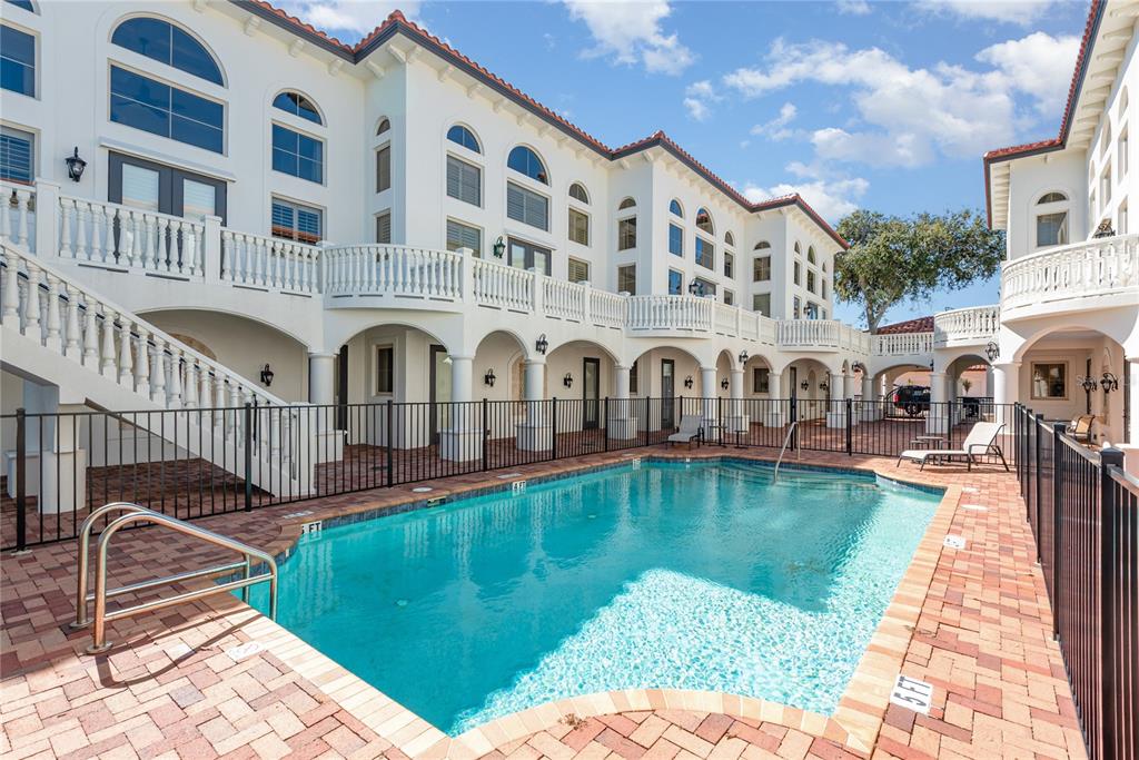 5090 Riverside Drive, Unit 103 Port Orange, FL 32127 - Photo 12 of 62 a swimming pool with outdoor seating yard and deck