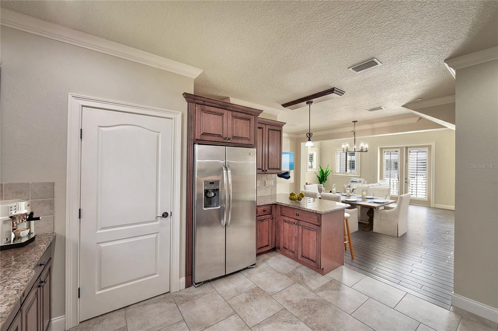 5090 Riverside Drive, Unit 103 Port Orange, FL 32127 - Photo 27 of 62 a kitchen with stainless steel appliances granite countertop a refrigerator and a stove