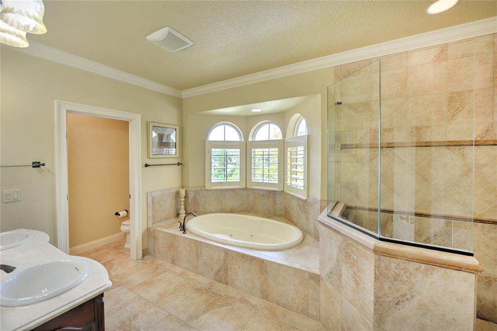 5090 Riverside Drive, Unit 103 Port Orange, FL 32127 - Photo 37 of 62 a bath room with a bath tub and shower