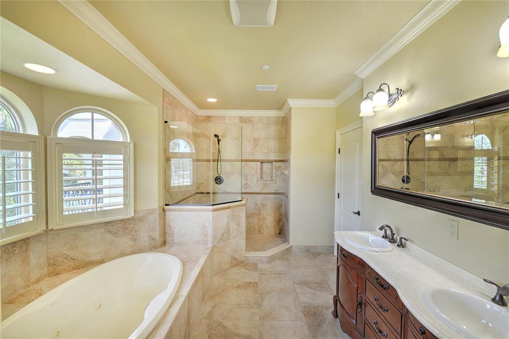 5090 Riverside Drive, Unit 103 Port Orange, FL 32127 - Photo 38 of 62 a spacious bathroom with a tub sink and mirror
