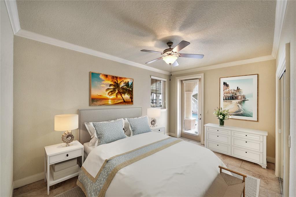 5090 Riverside Drive, Unit 103 Port Orange, FL 32127 - Photo 44 of 62 a bedroom with a bed and a chandelier