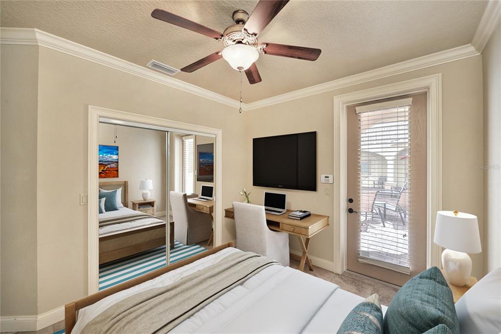 5090 Riverside Drive, Unit 103 Port Orange, FL 32127 - Photo 46 of 62 a bedroom with a bed and a flat screen tv