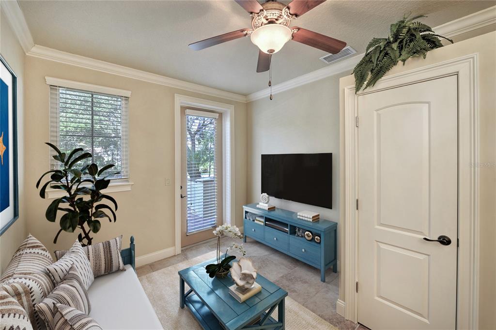 5090 Riverside Drive, Unit 103 Port Orange, FL 32127 - Photo 49 of 62 a living room with furniture and a flat screen tv
