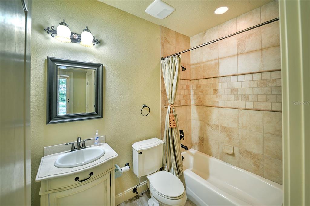 5090 Riverside Drive, Unit 103 Port Orange, FL 32127 - Photo 50 of 62 a bathroom with a sink toilet and shower