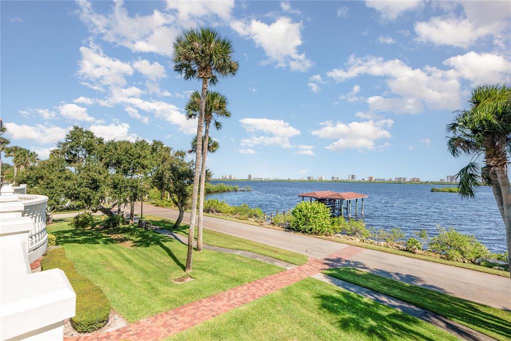 5090 Riverside Drive, Unit 103 Port Orange, FL 32127 - Photo 55 of 62 a view of a lake with a big yard