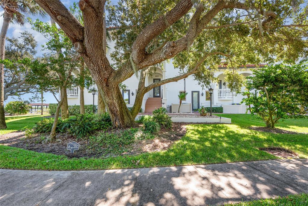 5090 Riverside Drive, Unit 103 Port Orange, FL 32127 - Photo 58 of 62 a front view of a house with a garden
