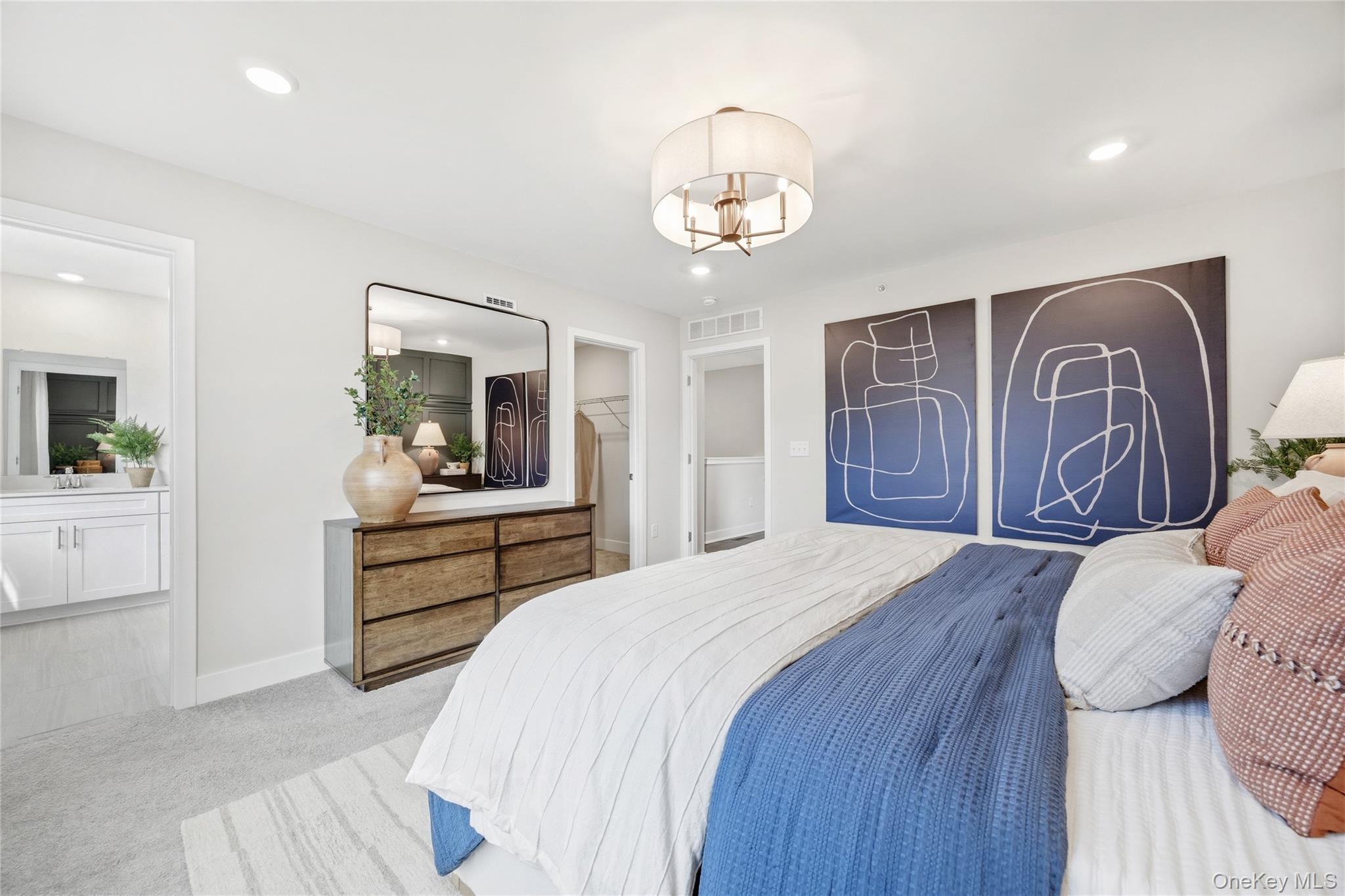 154 Pine Ridge Road Tuxedo Park, NY 10987 - Photo 17 of 25 a bedroom with a large bed and a chandelier
