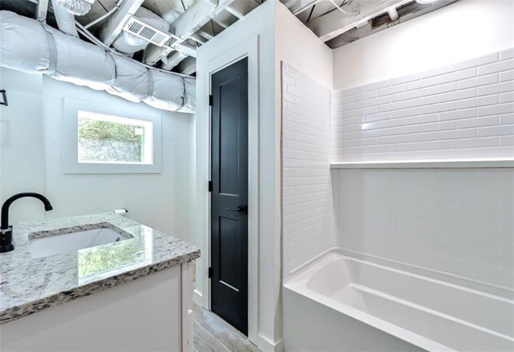 2218 Belvedere Avenue Southwest Atlanta, GA 30311 - Photo 11 of 13 a bath tub sitting next to a bathroom sink