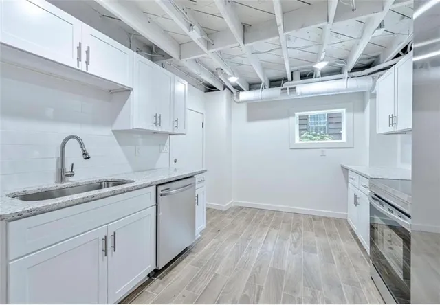 a kitchen with a sink stove and cabinets