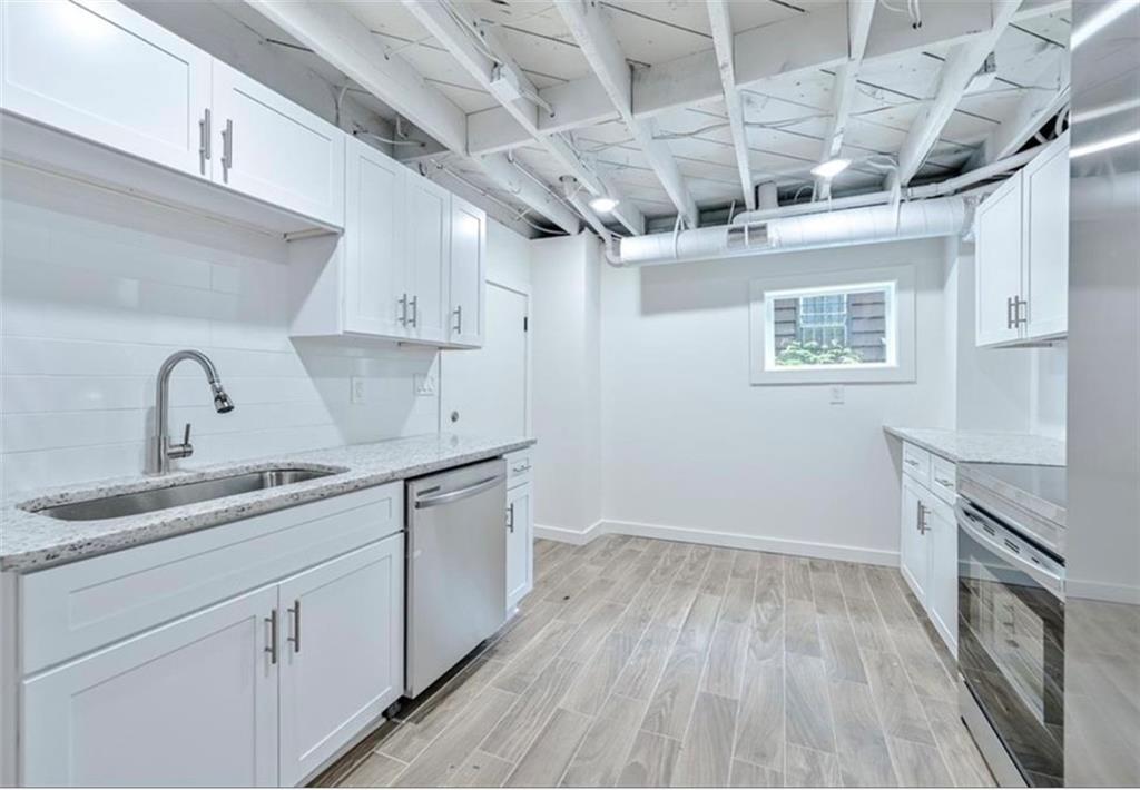 2218 Belvedere Avenue Southwest Atlanta, GA 30311 - Photo 3 of 13 a kitchen with a sink stove and cabinets