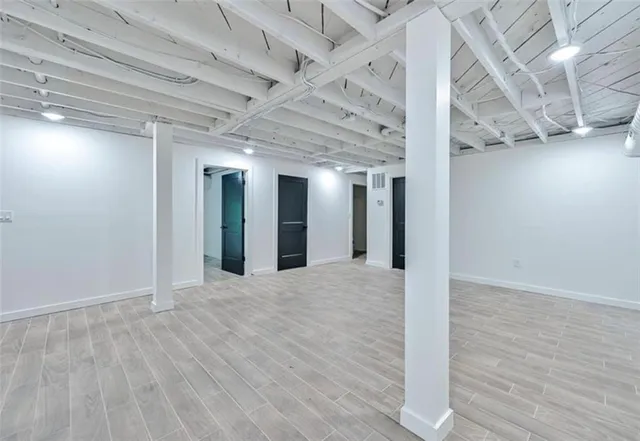a view of an empty room with wooden floor