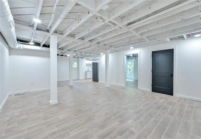 a view of empty room with wooden floor