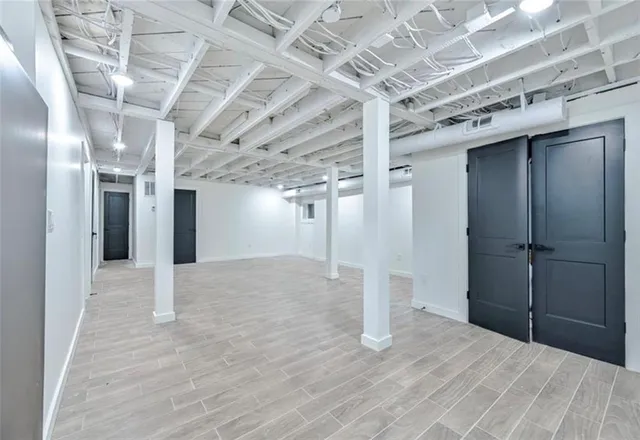 a view of a hallway with wooden walls