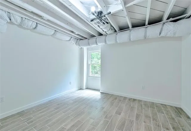 a view of a room with wooden floor