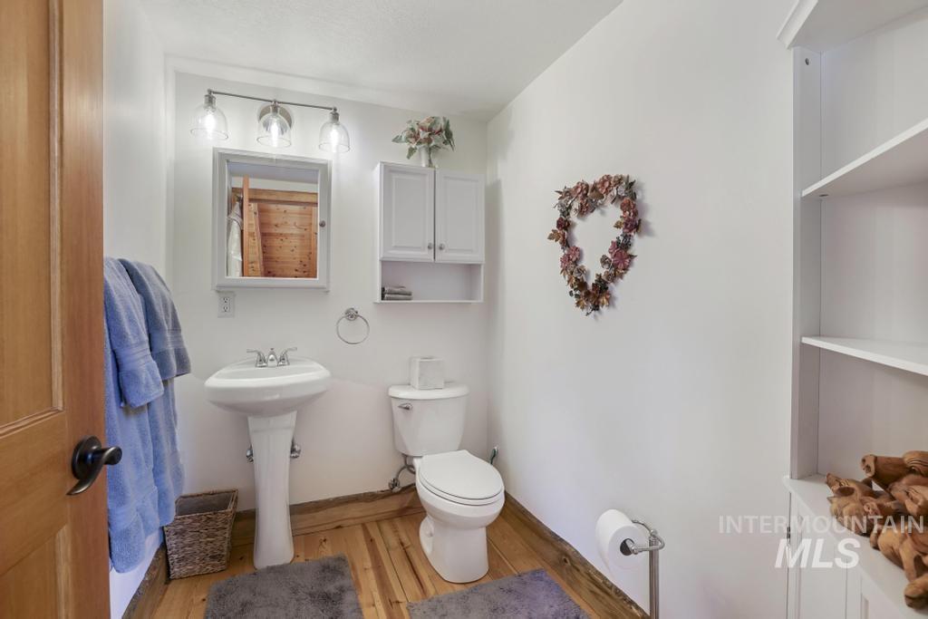 65 Goat Creek Way Stanley, ID 83278 - Photo 20 of 32 Bathroom featuring a pedestal sink, wall-mounted medicine cabinet, and white built-in shelving