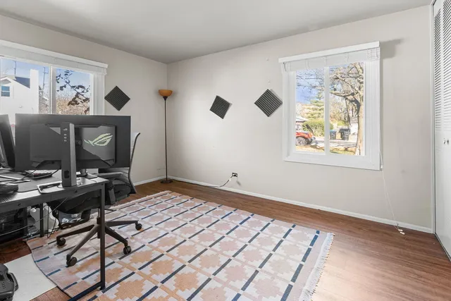 a view of a workspace with furniture and a window