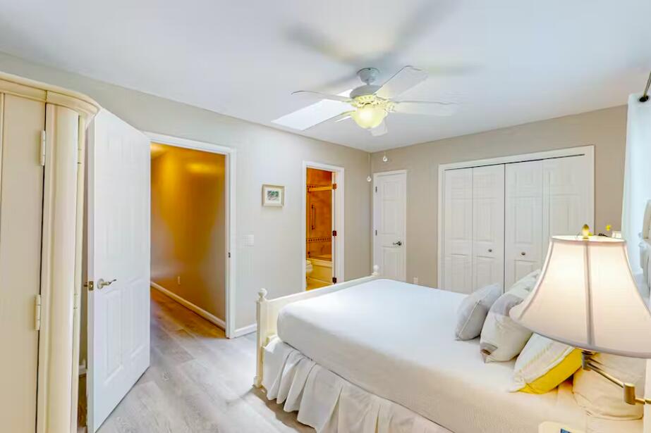241 Ellis Road, Unit 8 Miramar Beach, FL 32550 - Photo 12 of 29 a bedroom with a bed and a chandelier