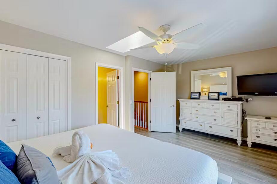 241 Ellis Road, Unit 8 Miramar Beach, FL 32550 - Photo 17 of 29 a bedroom with a bed and a chandelier