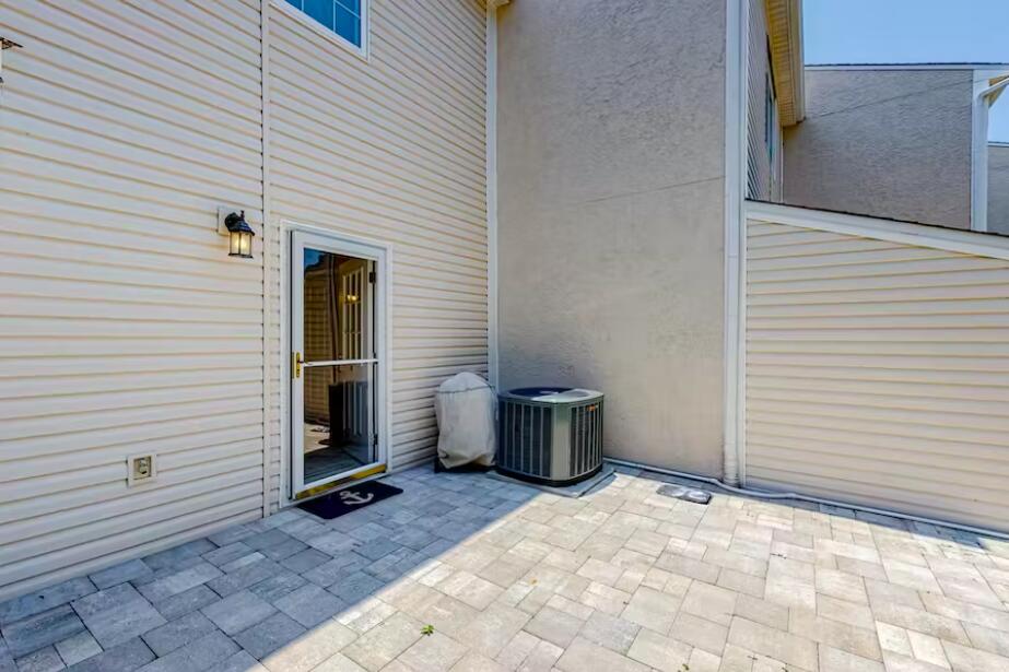 241 Ellis Road, Unit 8 Miramar Beach, FL 32550 - Photo 22 of 29 a view of a patio with chair and door