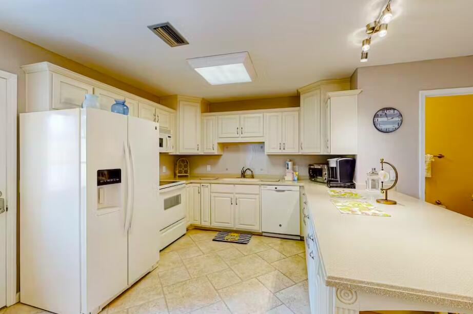 241 Ellis Road, Unit 8 Miramar Beach, FL 32550 - Photo 7 of 29 a kitchen with a refrigerator a stove a sink and cabinets