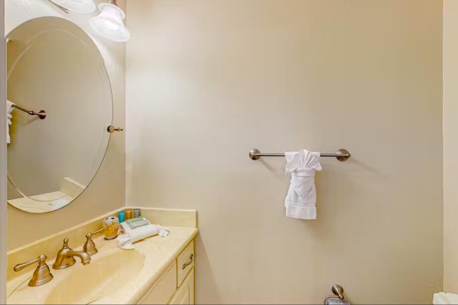 241 Ellis Road, Unit 8 Miramar Beach, FL 32550 - Photo 9 of 29 a bathroom with a sink a toilet and mirror