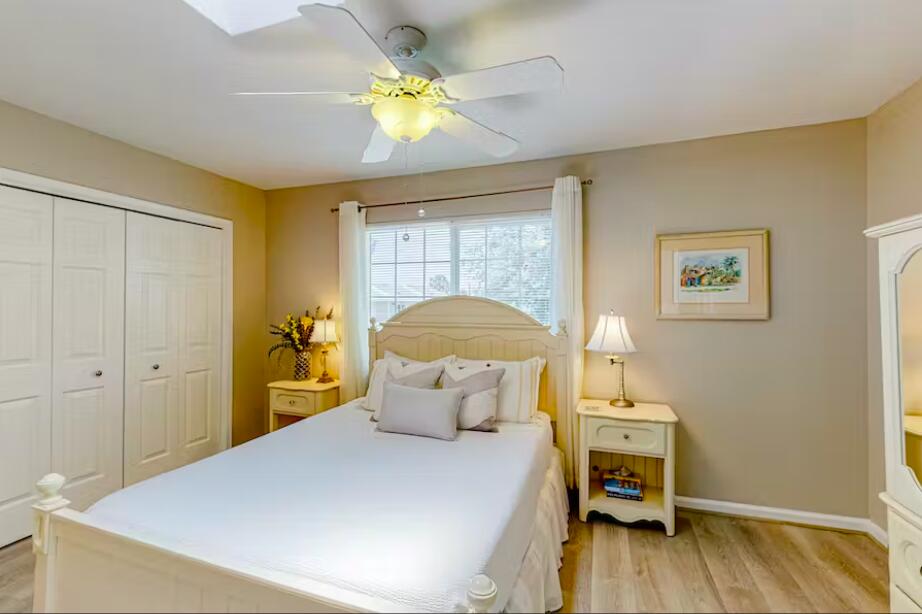 241 Ellis Road, Unit 8 Miramar Beach, FL 32550 - Photo 10 of 29 a bedroom with a bed and wooden floor