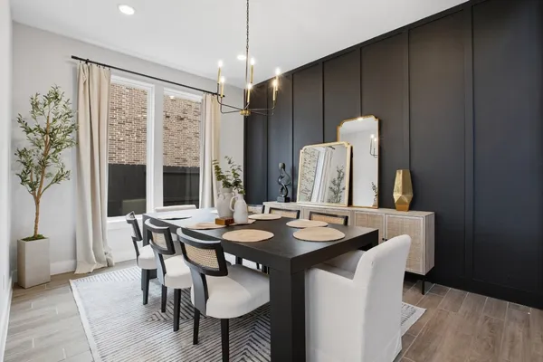 a view of a a dining room with furniture window and wooden floor