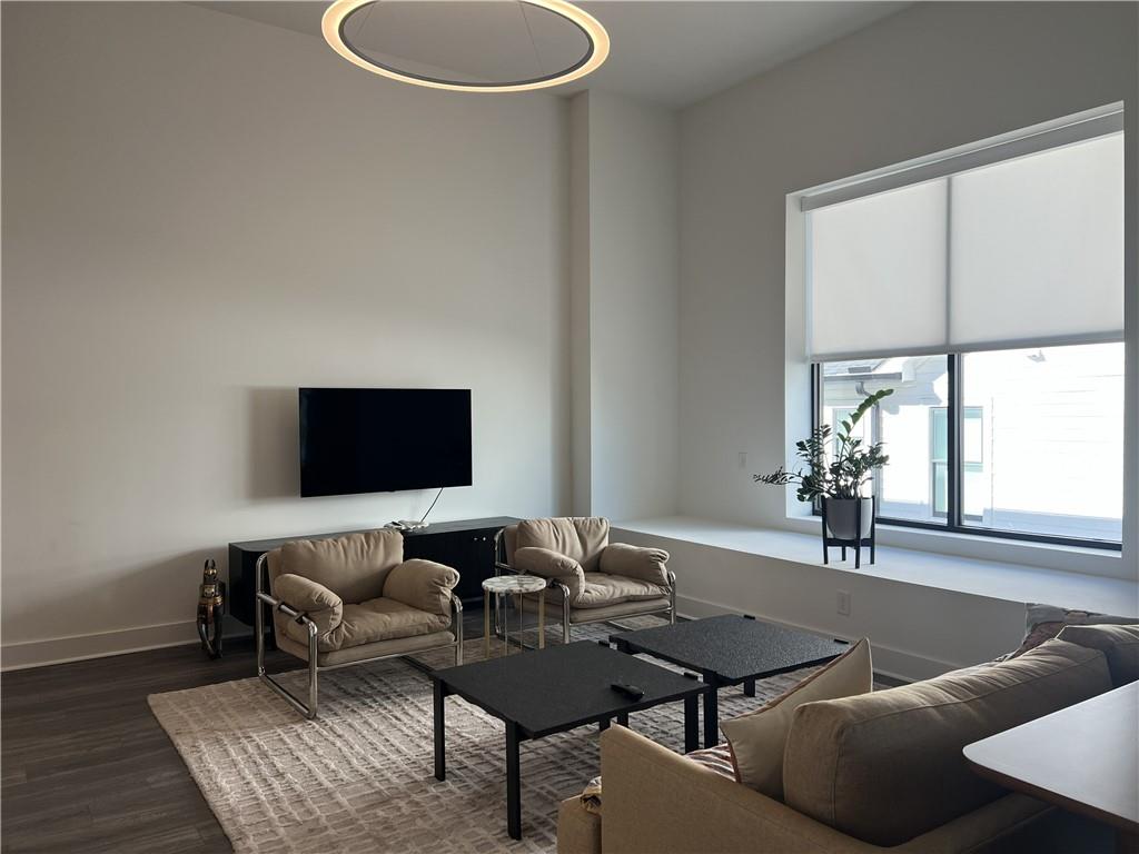 108 Park Place, Unit 311 Decatur, GA 30030 - Photo 11 of 23 a living room with furniture and a flat screen tv