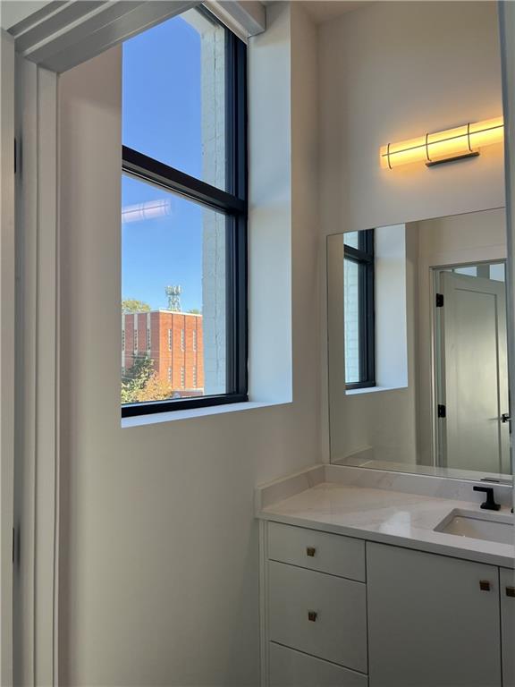 108 Park Place, Unit 311 Decatur, GA 30030 - Photo 14 of 23 a bathroom with a granite countertop sink and a mirror