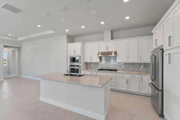 a kitchen with refrigerator and cabinets
