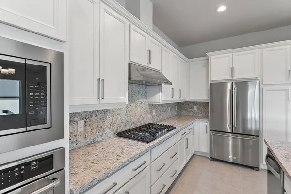 a view of a kitchen with furniture and a kitchen counter top space