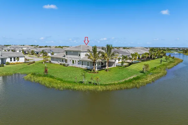 a view of a swimming pool with a yard and lake view
