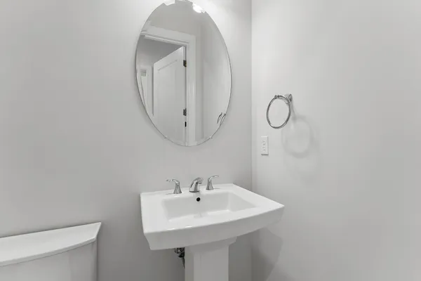 a bathroom with a granite countertop sink a toilet and shower