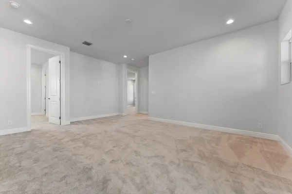 a front view of a house with garden and trees