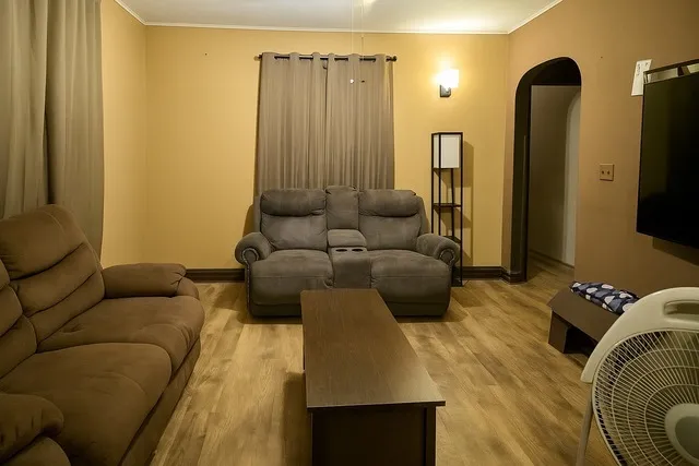 a living room with furniture and a flat screen tv