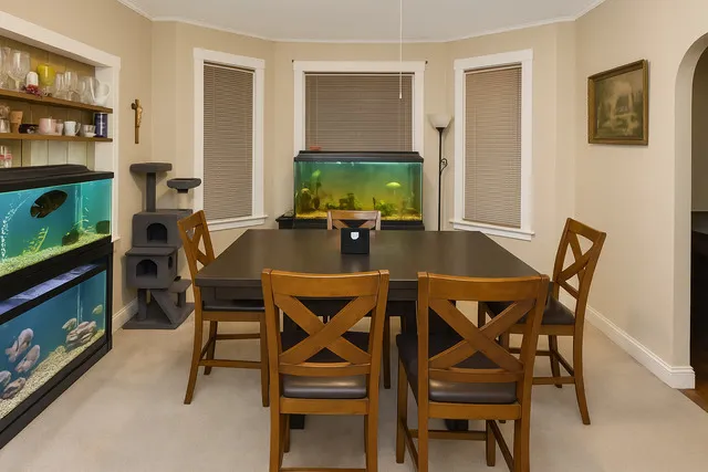 a view of a dining room with furniture and wooden floor