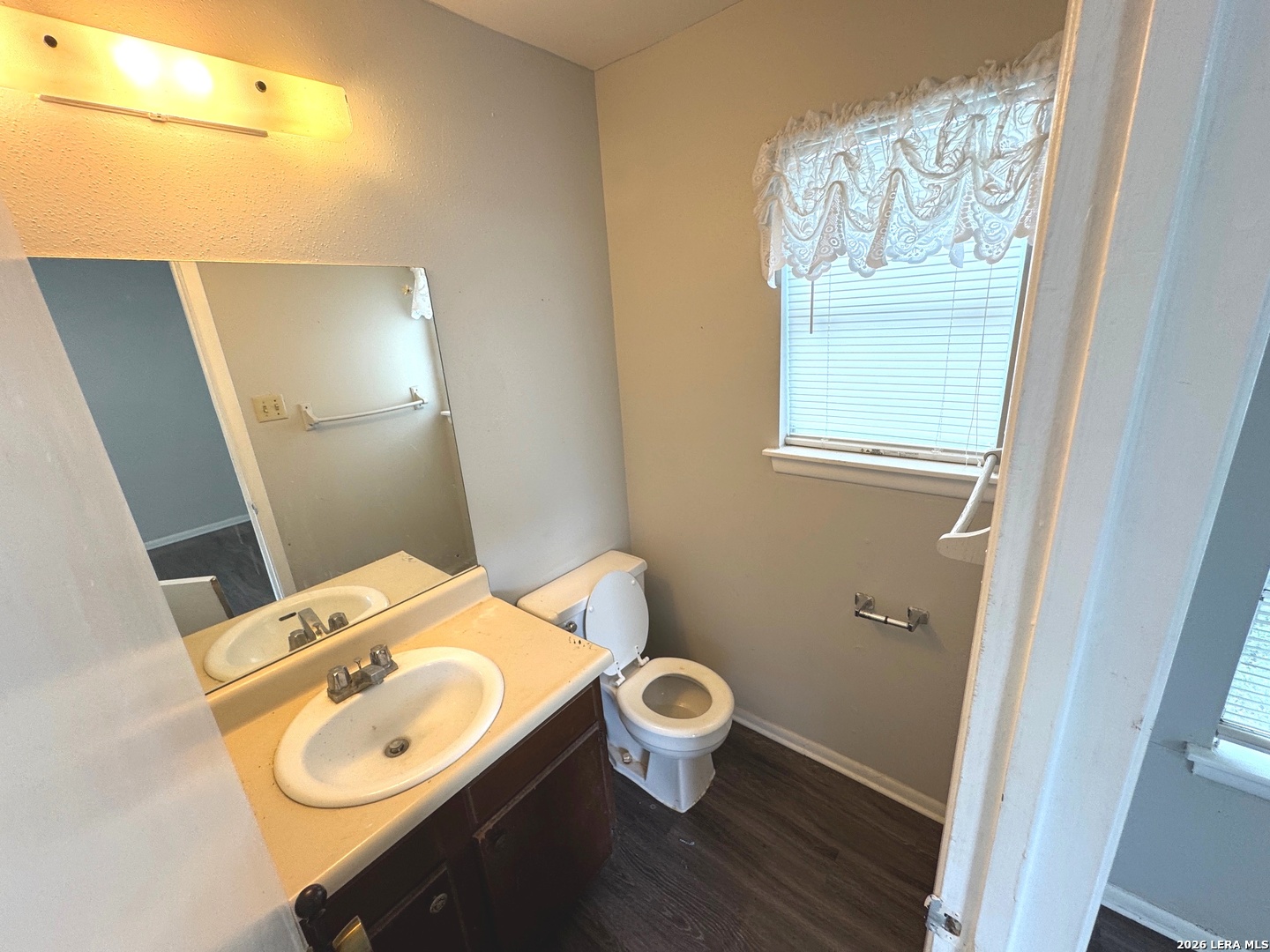 7300 Deep Spring Drive San Antonio, TX 78238 - Photo 8 of 9 a bathroom with a toilet sink and mirror