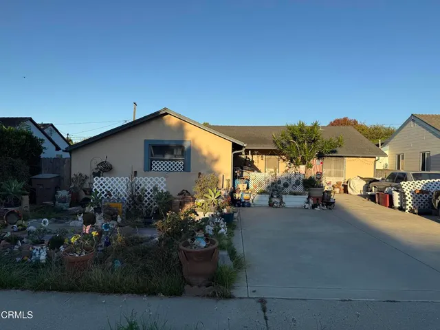 a view of a house with a yard and sitting area