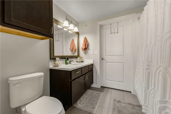 a bathroom with a sink vanity mirror and toilet