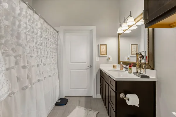 a en suite bathroom with a sink a mirror and a shower