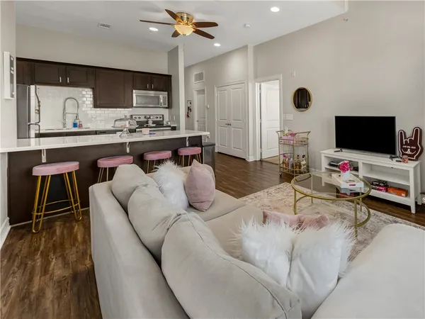 a living room with furniture and a flat screen tv