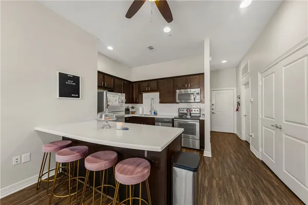 a view of kitchen with cabinets table and chairs