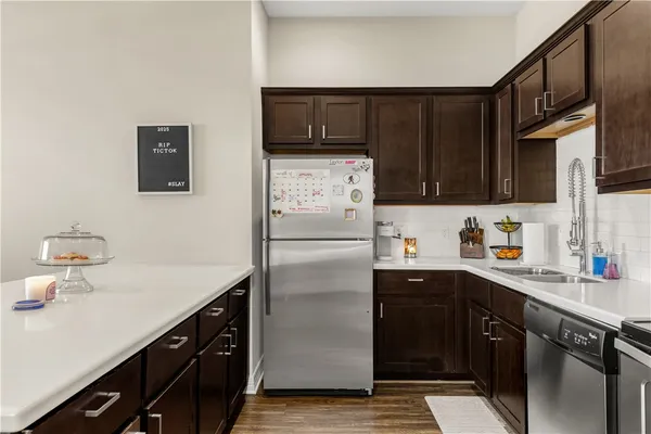 a kitchen with stainless steel appliances granite countertop a refrigerator and a sink