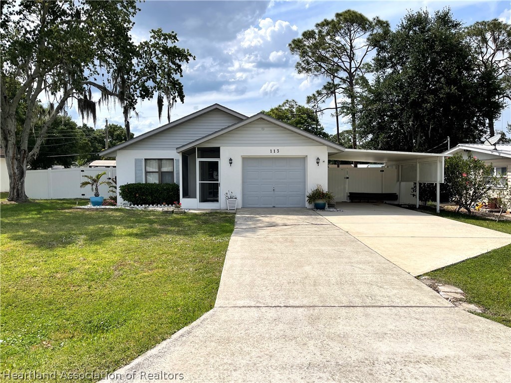 113 Longview Road Sebring, FL 33870 - Photo 1 of 31 a house view with a garden space