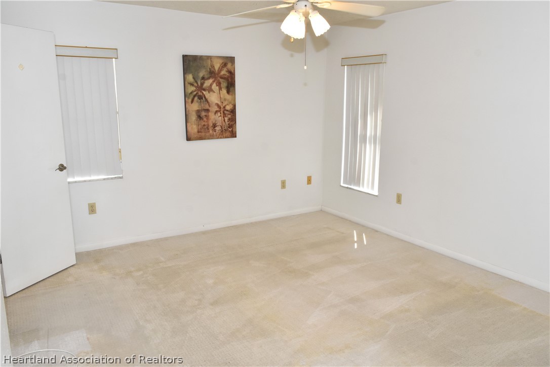 113 Longview Road Sebring, FL 33870 - Photo 12 of 31 an empty room with windows and fan