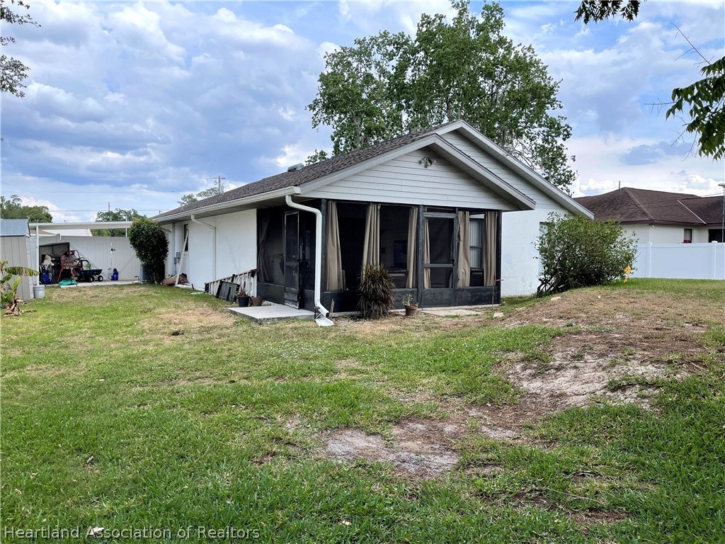 113 Longview Road Sebring, FL 33870 - Photo 23 of 31 a view of a house with yard and a garden
