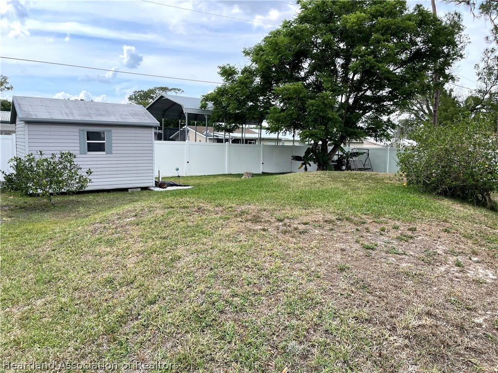 113 Longview Road Sebring, FL 33870 - Photo 24 of 31 a view of a backyard with plants and large tree