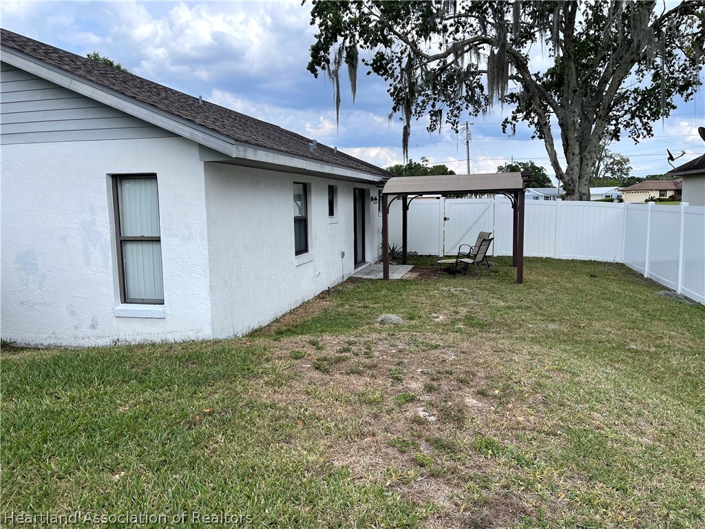 113 Longview Road Sebring, FL 33870 - Photo 25 of 31 a house that has a tree in front of it